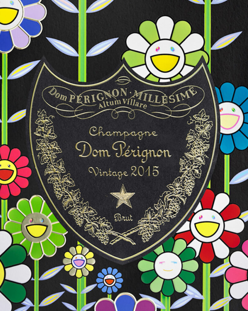 A Takashi Murakami Dom Perignon Vintage 2015 champagne label is centered against a colorful background of cartoon flowers with smiling faces.