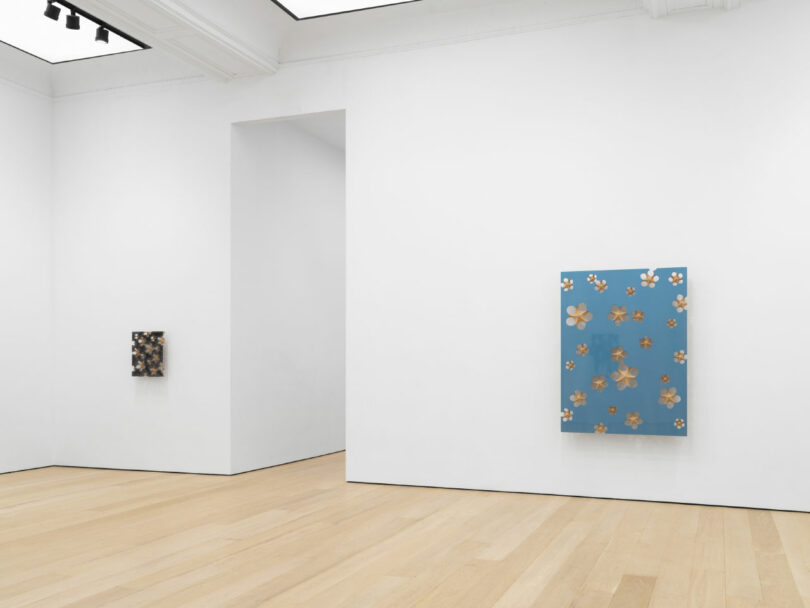 Dark gray and light blue paintings in gallery