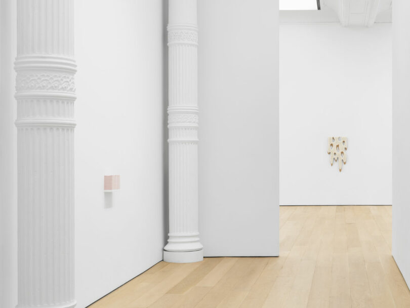 Gallery with stack of bumper stickers and painting