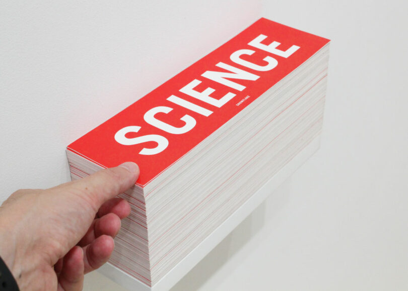 hand reaching for free bumper sticker